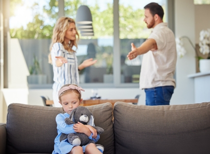 Kid feeling upset while parents argue in room