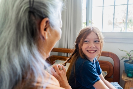 Grandmother doing braids on granddaughter